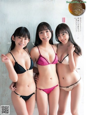 A group of three young women posing for a picture.