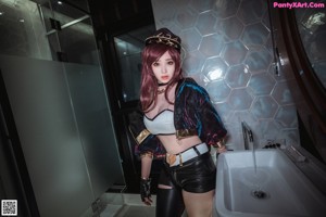 A woman in a bikini and hat sitting in a bathtub.