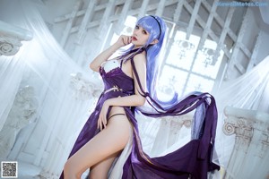 A woman with long blue hair wearing a purple lingerie.