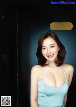 A woman in a black lingerie sitting on a chair.