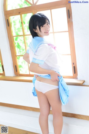 A woman in a blue and white uniform posing for a picture.