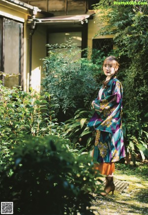 A woman sitting on top of a wooden table.