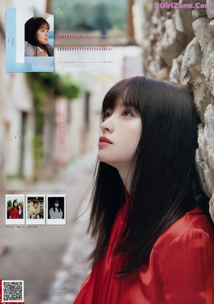 A woman in a black dress on the cover of a magazine.