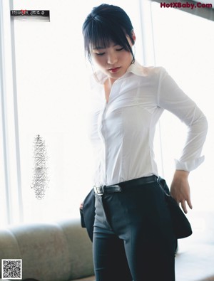 A woman in a blue dress sitting on the floor.