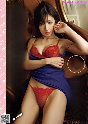 A woman in a bathtub and a woman sitting on a chair.