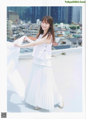 A woman with long brown hair is posing for a picture.