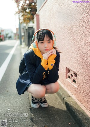 A magazine with a picture of a young woman on the cover.