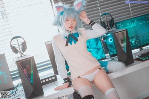 A woman with blue hair wearing a white dress and headphones.