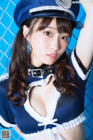 A woman in a police uniform is posing for a picture.
